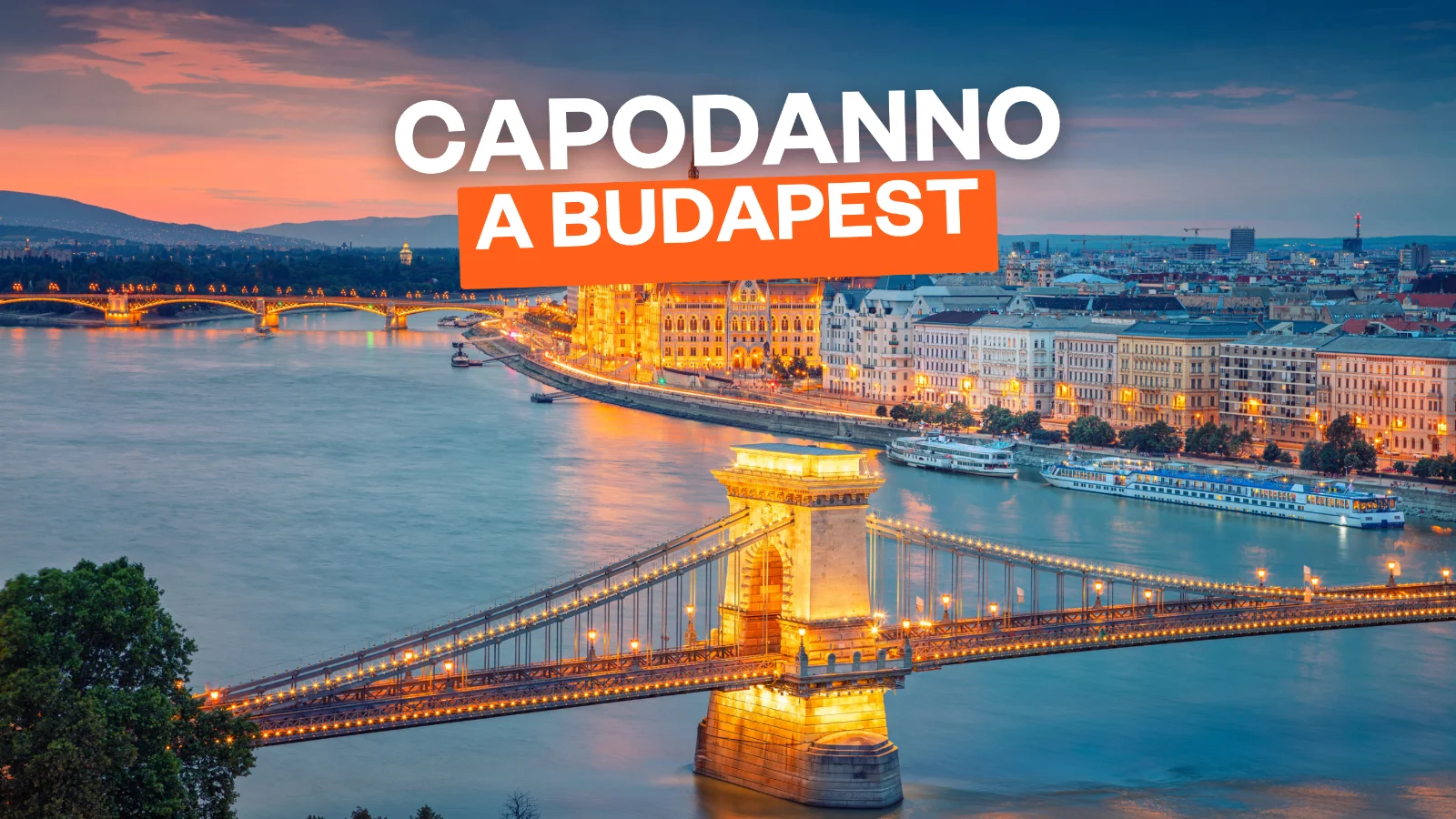 Aerial cityscape image of Budapest with Chain Bridge and parliament building during summer sunset.